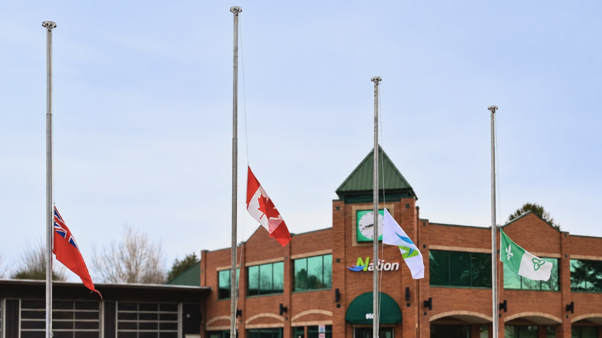 Picture of flags half masted at Town Hall.