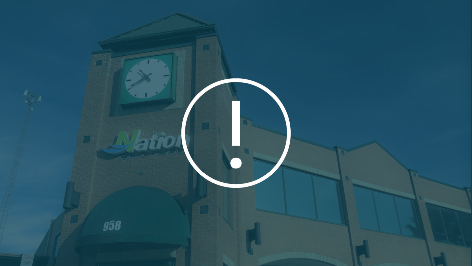 Decorative image - White exclamation point icon with picture of town hall in the background