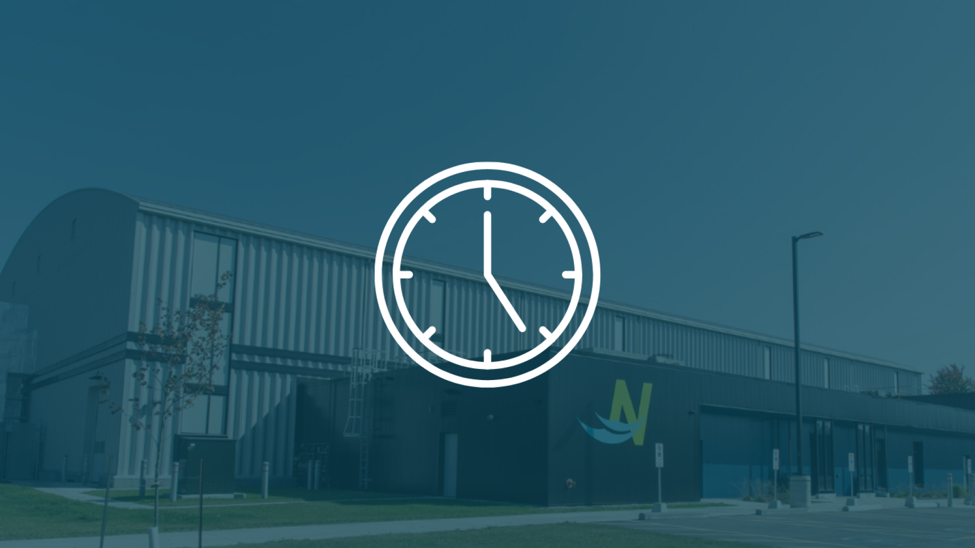 White clock icon in front of a blue background displaying the sports complex