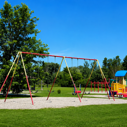 Play structures and swings on a summer day with bright blue skies