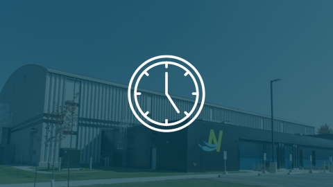 White clock icon in front of a blue background displaying the sports complex